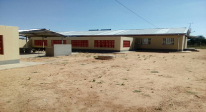 Single-storey building and its unpaved surroundings